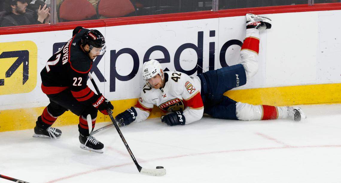 Carolina’s Logan Stankoven (22) controls the puck past Panthers’ Gustav Forsling (42) during the second period of the Carolina Hurricanes’ game against the Florida Panthers in Game 1 of the Eastern Conference Finals at the Lenovo Center in Raleigh, N.C., Tuesday, May 20, 2025.