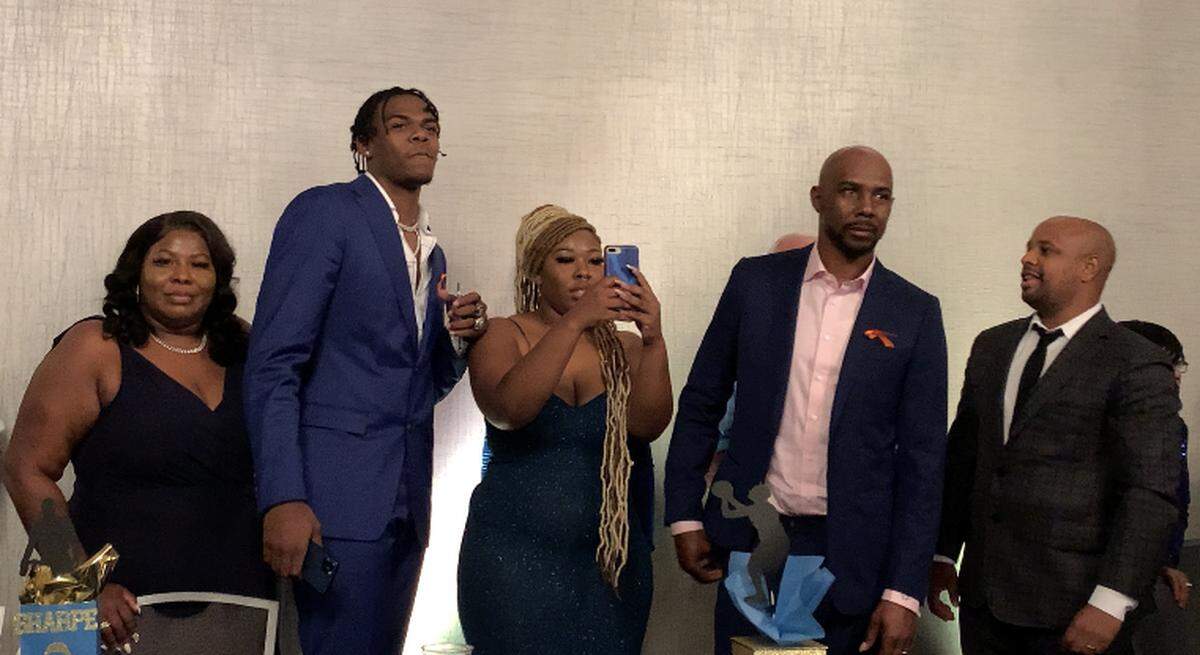 Former UNC forward Day’Ron Sharpe, second from left, awaits hearing his name announced on the broadcast of the NBA draft Thursday, July 29, at the Greenville Convention Center. He is flanked by his mother, sister, father and agent.