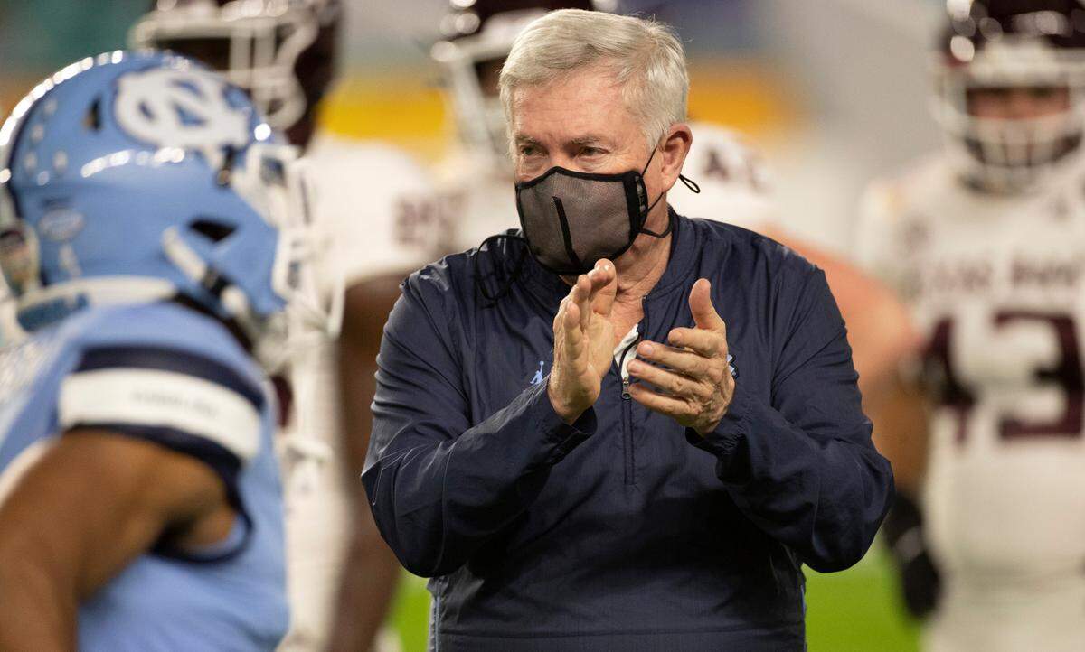 North Carolina coach Mack Brown applauds his players as they enter Hard Rock Stadium for the Tar Heels’ game against Texas A&M in the Capital One Orange Bowl on Saturday, January 2, 2021in Miami Gardens, Florida.