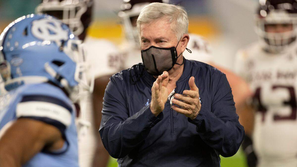 North Carolina coach Mack Brown applauds his players as they enter Hard Rock Stadium for the Tar Heels’ game against Texas A&M in the Capital One Orange Bowl on Saturday, January 2, 2021in Miami Gardens, Florida.