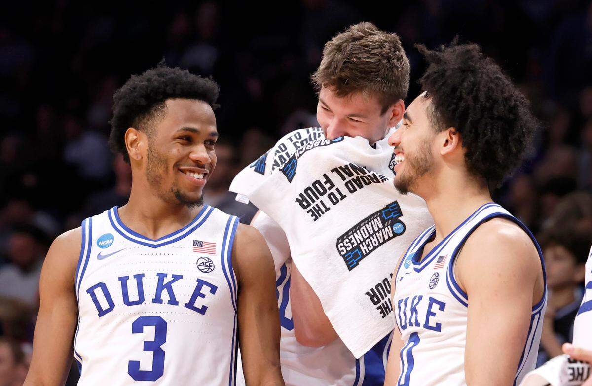 Duke’s Kyle Filipowski (30) laughs with Jeremy Roach (3) and Jared McCain (0) late in the second half of Duke’s 93-55 victory over James Madison in the second round of the NCAA Tournament at the Barclays Center in Brooklyn, N.Y., Sunday, March 24, 2024.