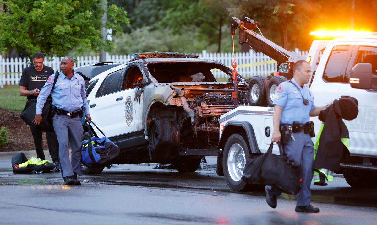 A burned out police vehicle is ready to be towed outside the police station in Southeast Raleigh Saturday, May 7, 2022. Raleigh police said a man died earlier Saturday after four police officers shot him outside the station. Police officers shot him after they saw him throwing “multiple” Molotov cocktails at vehicles in a parking lot near the police station, Chief Estella Patterson said at a news conference Saturday night. He then threw the “incendiary weapons” toward officers, and one came within close proximity of an officer, Patterson said.