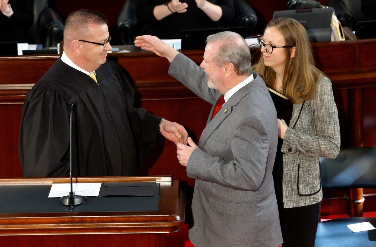 N.C. Sen Phil Berger hugs his son N.C. Supreme Court Justice Philip Berger, Jr., after Sen. Berger took the oath as President Pro Tempore during the opening session of N.C. Senate Wednesday, Jan. 8, 2025. With Sen. Berger is his daughter Ashley Snyder.