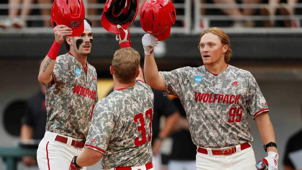 NC State’s Garrett Pennington (33) celebrates with his teammates after hitting a home run during Game 3 of the Super NCAA Regional against Georgia at Foley Field on Monday, June 10, 2024 in Athens, Ga. NC State won 8-5.