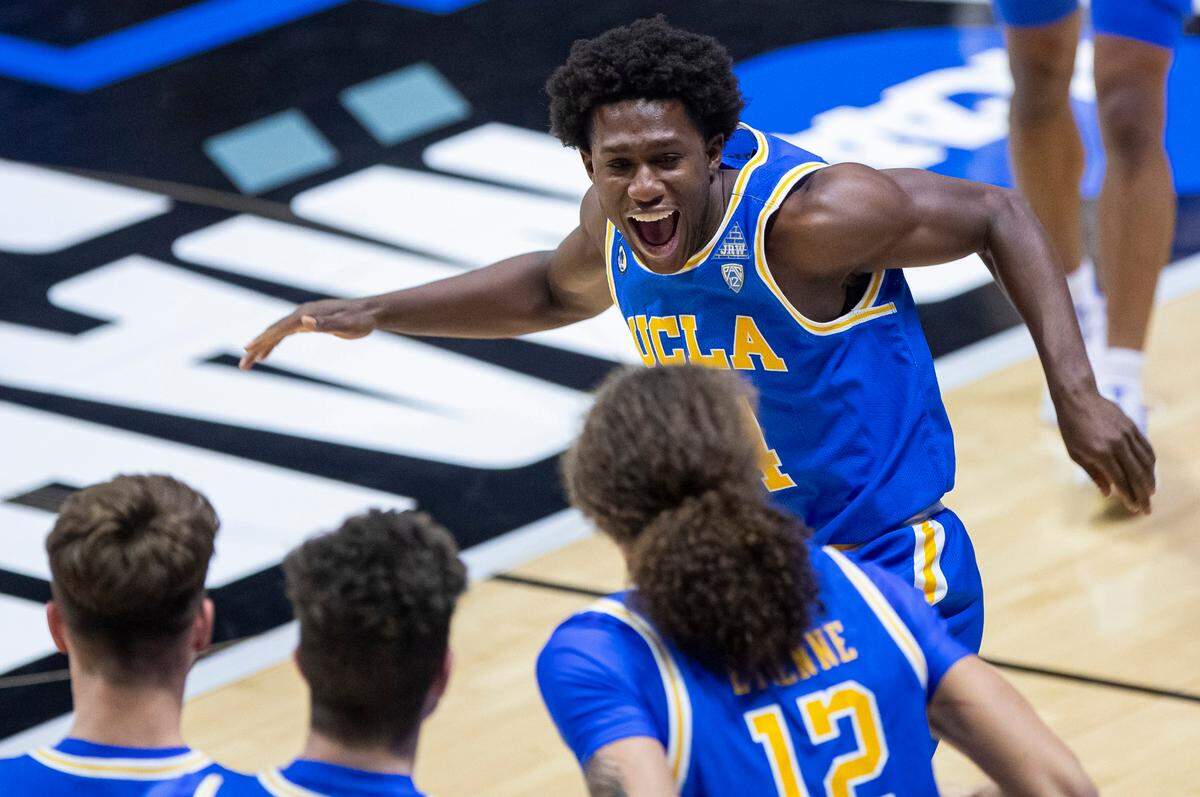 UCLA’s David Singleton, top, runs to celebrate with teammates following their 86-80 win over Michigan State in a First Four game in the NCAA men’s college basketball tournament, early Friday, March 19, 2021, at Mackey Arena in West Lafayette, Ind. (AP Photo/Robert Franklin)