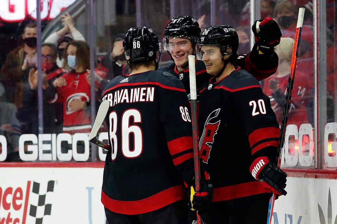 Carolina Hurricanes’ Teuvo Teravainen (86) and Andrei Svechnikov (37) congratulate teammate Sebastian Aho (20) on his goal during the second period of an NHL hockey game against the Chicago Blackhawks in Raleigh, N.C., Monday, May 3, 2021. (AP Photo/Karl B DeBlaker)
