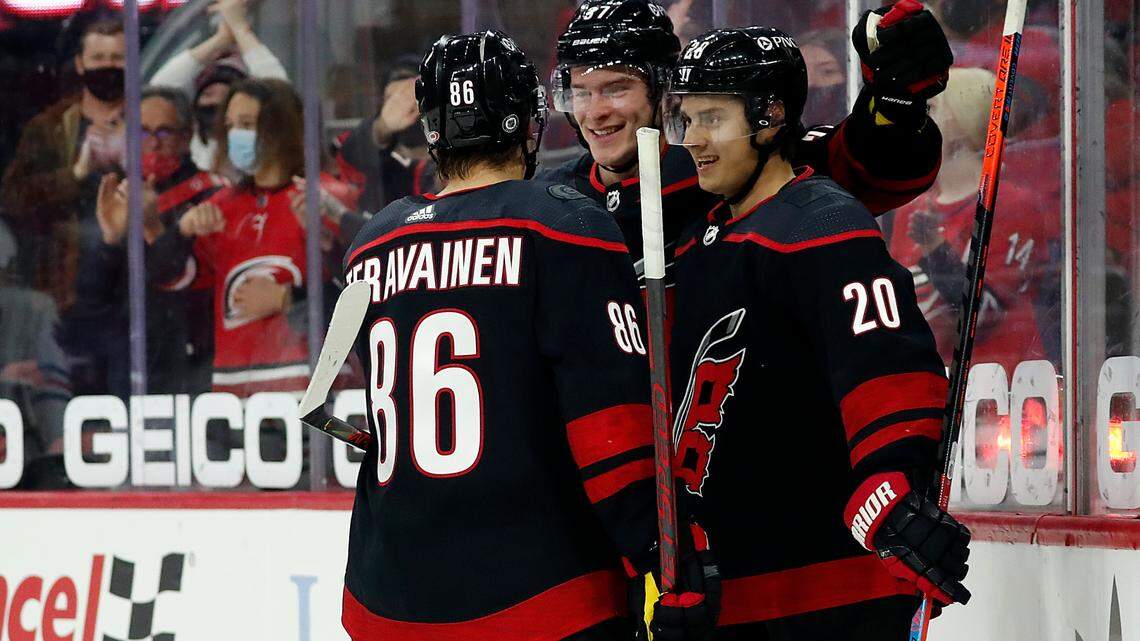 Carolina Hurricanes’ Teuvo Teravainen (86) and Andrei Svechnikov (37) congratulate teammate Sebastian Aho (20) on his goal during the second period of an NHL hockey game against the Chicago Blackhawks in Raleigh, N.C., Monday, May 3, 2021. (AP Photo/Karl B DeBlaker)