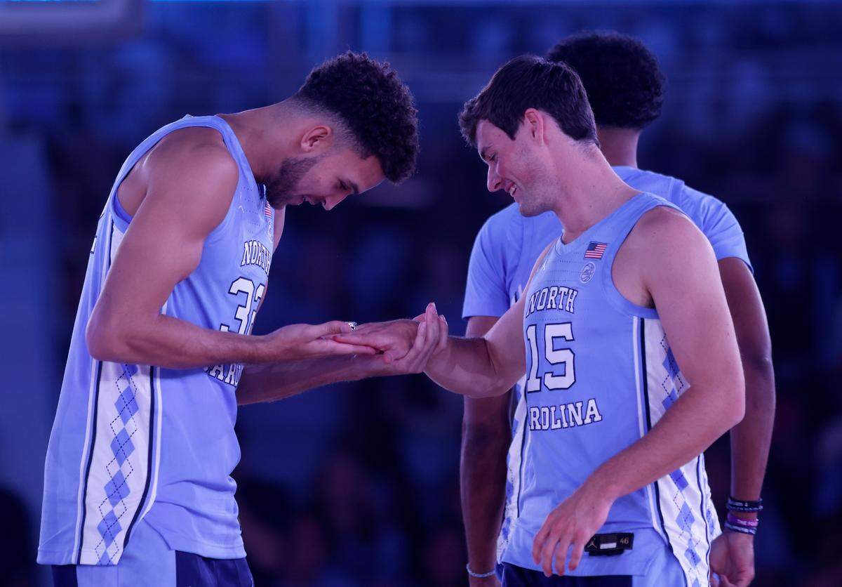North Carolina’s Pete Nance admires the Final Four ring of Rob Landry during “Live Action with Carolina Basketball” at the Dean E. Smith Center on Friday, Oct. 7, 2022, in Chapel Hill, N.C.