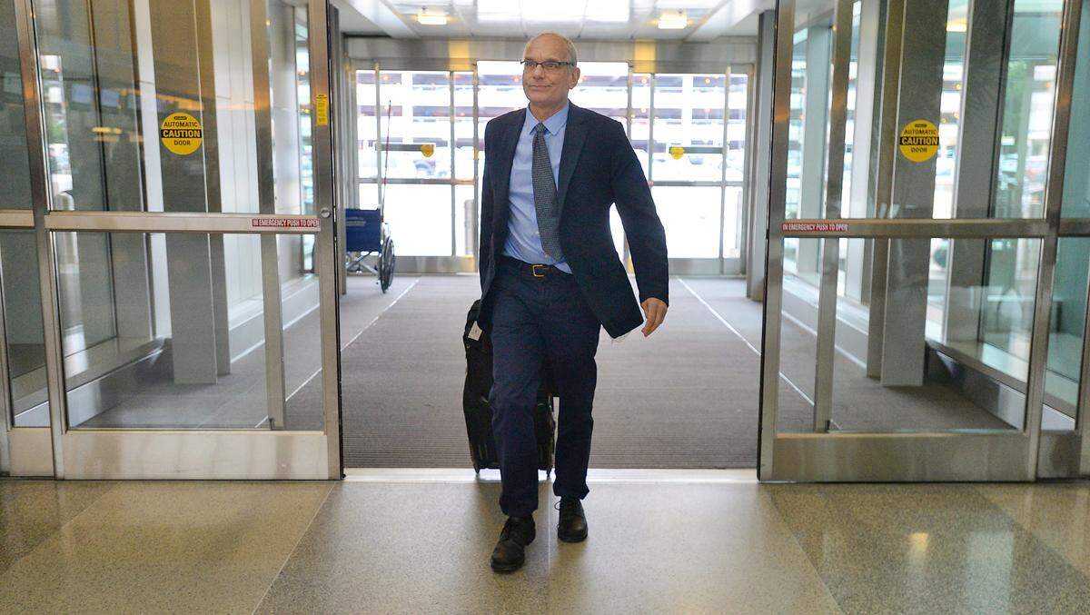 Dr. Charles van der Horst heads for the ticket counter at RDU International Airport Thursday, November 13, 2014 on his way to Liberia to work on Ebola relief efforts.