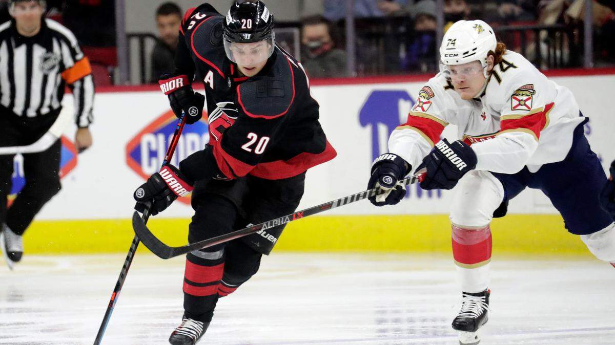 Carolina Hurricanes center Sebastian Aho (20) moves the puck against Florida Panthers right wing Owen Tippett (74) during the second period of an NHL hockey game Wednesday, Feb. 16, 2022, in Raleigh, N.C. (AP Photo/Chris Seward)