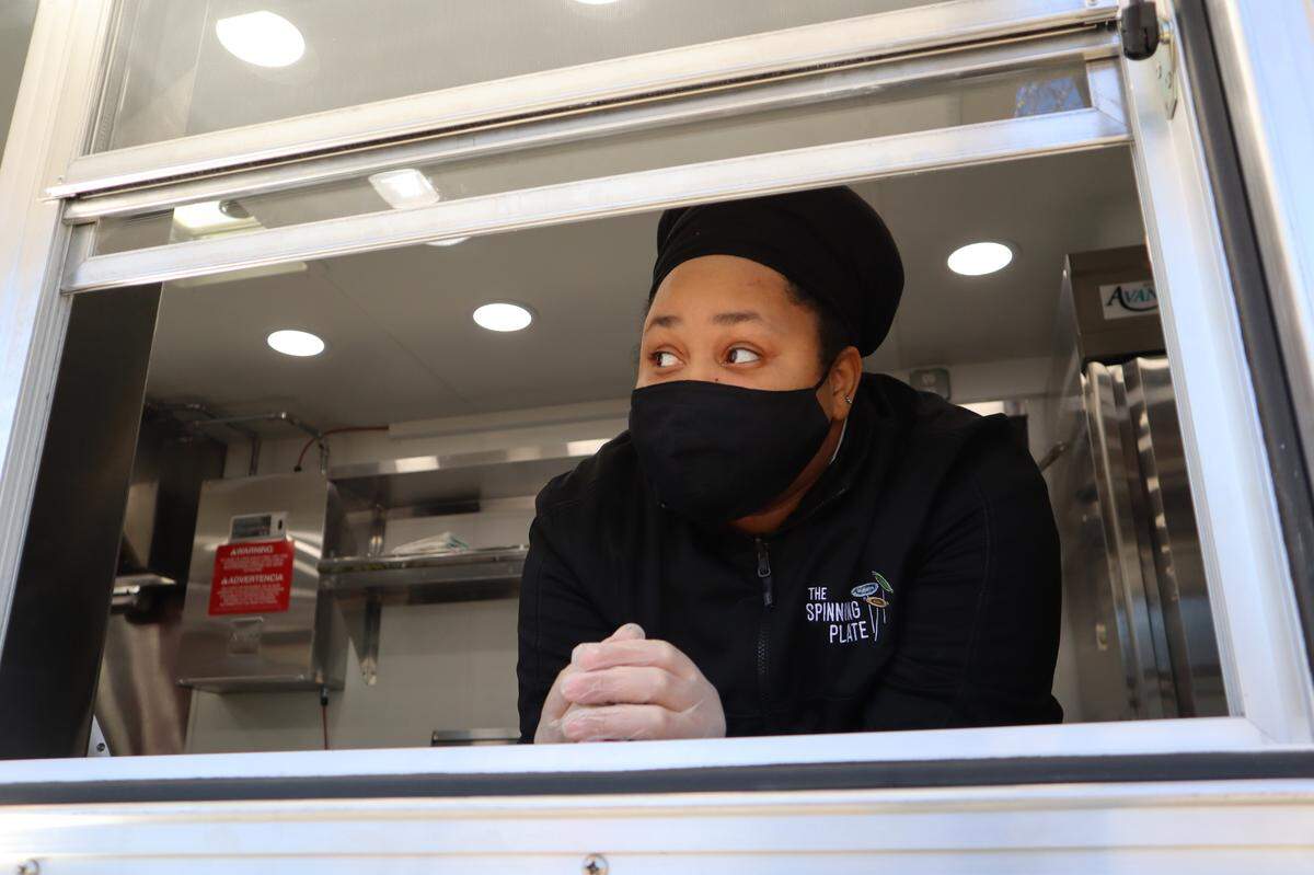 Dajai Johnson waits at the window of the Spinning Plate. The truck usually distributes meals one to three times weekly.