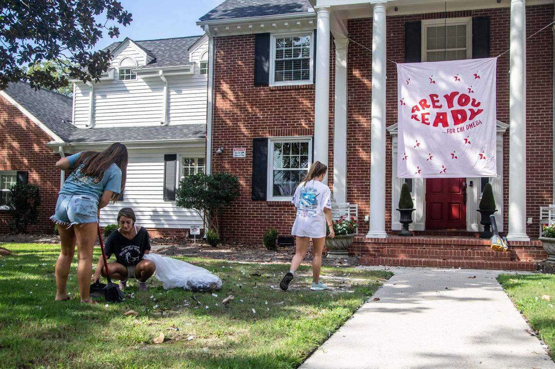 Students clean up confetti after making a recruitment video outside the Chi Omega sorority house August 18, 2020 near East Carolina University. The women said they were recruiting online this year.