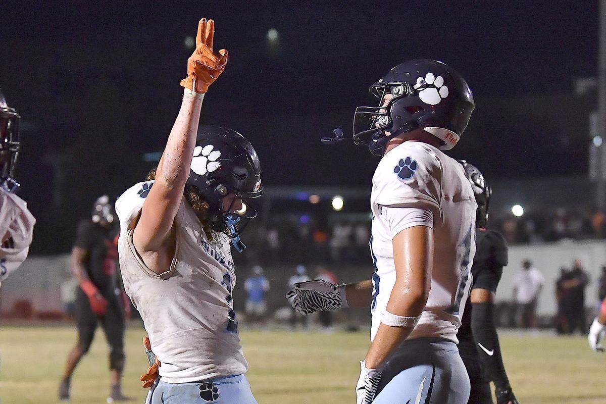 Millbrook's Quentin Cypher (4) celebrates his touchdown against Rolesville with Hayes Brawner (18) during the first half. The Millbrook Wildcats and the Rolesville Rams met in a conference football game in Rolesville, N.C. September 26, 2025