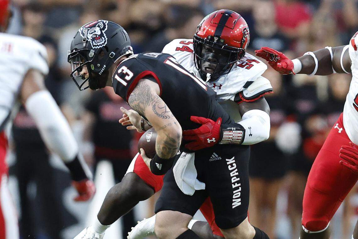 N.C. State quarterback Devin Leary (13) is sacked by Texas Tech linebacker Bryce Ramirez (54) during the first half of N.C. State’s game against Texas Tech at Carter-Finley Stadium in Raleigh, N.C., Saturday, Sept. 17, 2022.