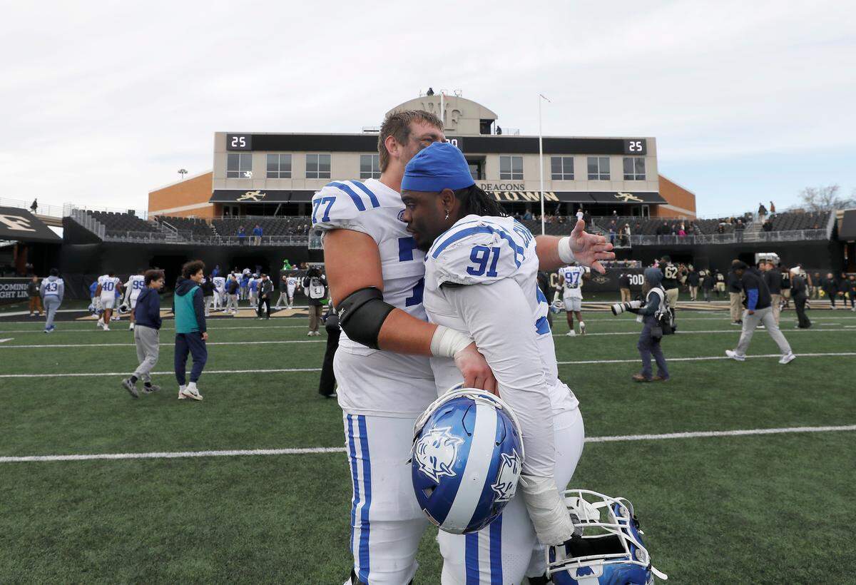 Duke’s Justin Pickett and Kendy Charles embrace following the Blue Devils’ 23-17 win over Wake Forest at Allegacy Stadium on Saturday, Nov. 30, 2024, in Winston-Salem, N.C.