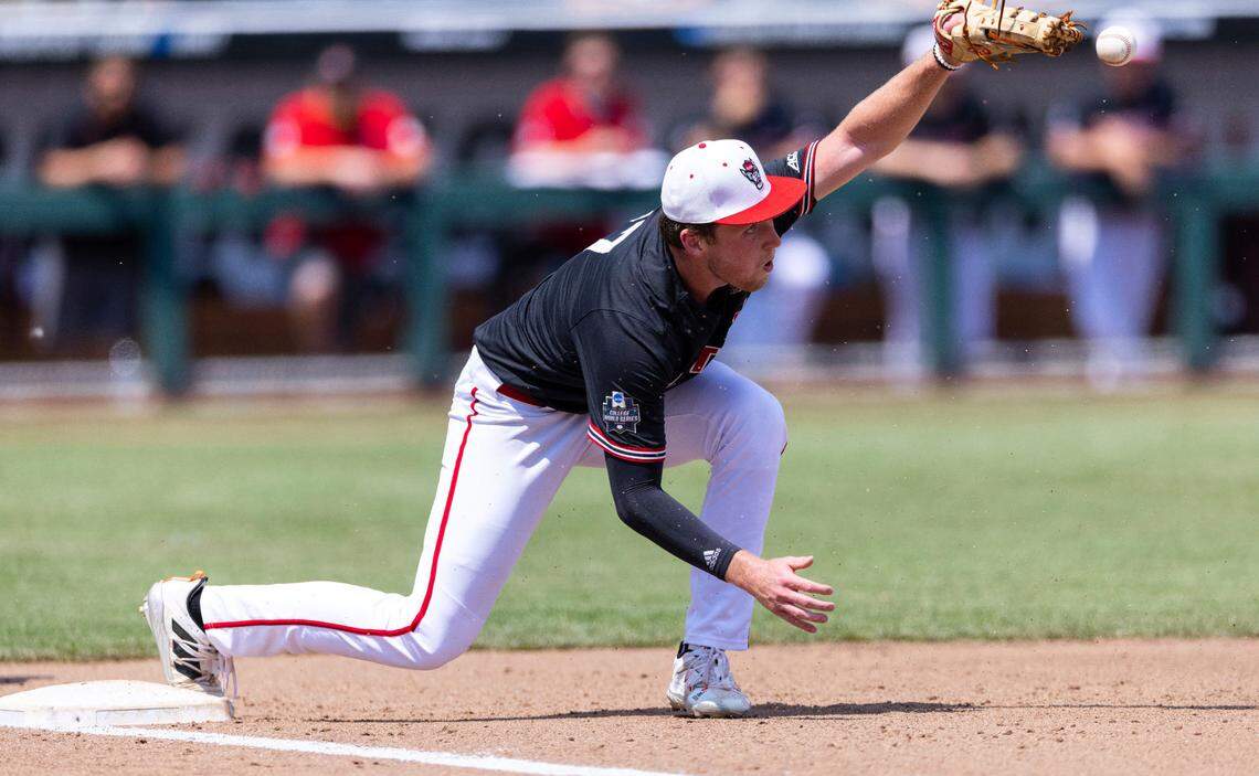 North Carolina State’s Sam Highfill misses the throw to first base, allowing Vanderbilt’s Dominic Keegan to reach on an error, in the fourth inning during a baseball game in the College World Series, Friday, June 25, 2021, at TD Ameritrade Park in Omaha.