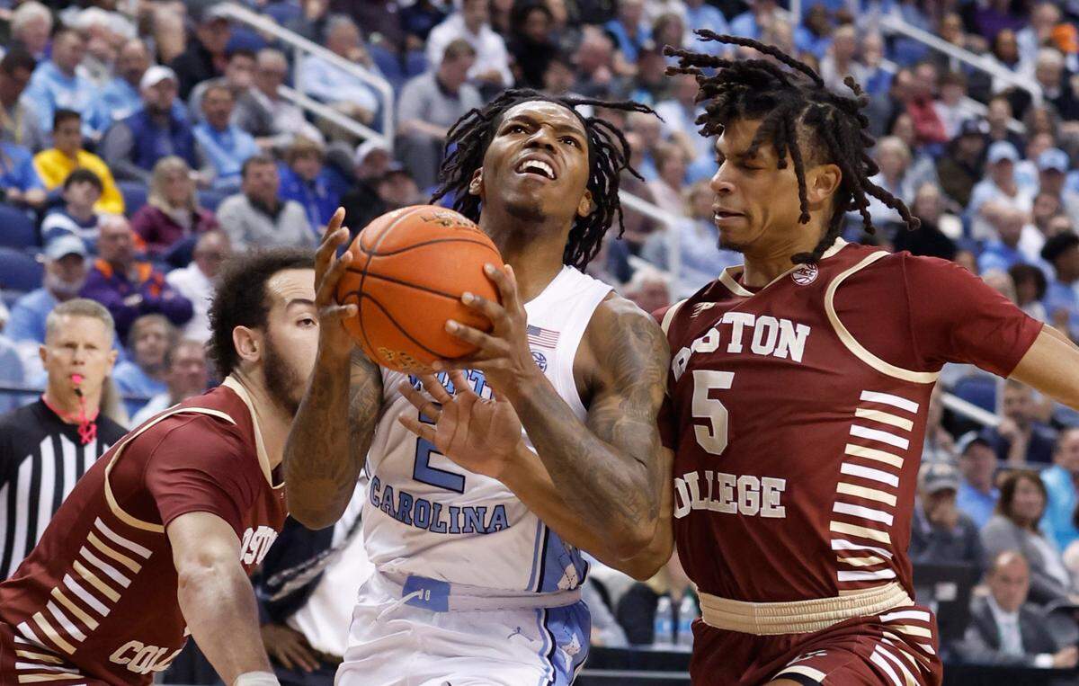 North Carolina’s Caleb Love (2) drives by Boston College’s Jaeden Zackery (3) and DeMarr Langford Jr. (5) during the first half of UNC’s game against Boston College in the second round of the New York Life ACC Men’s Basketball Tournament in Greensboro, N.C., Wednesday, March 8, 2023.