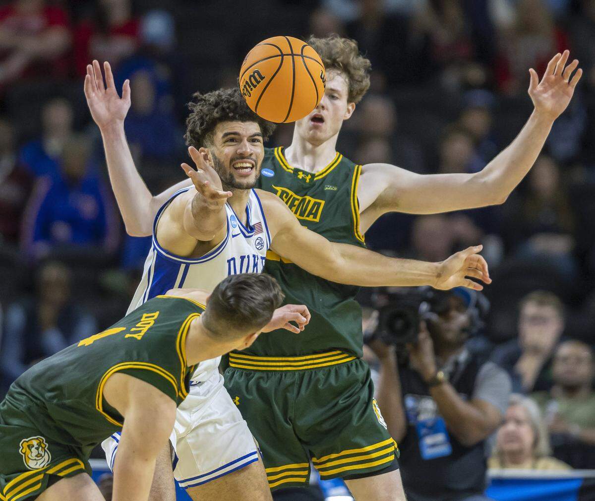 Siena center Riley Mulvey (55) and guard Gavin Doty (4) trap Duke forward Cameron Boozer (12) in the second half on Thursday, March 18, 2026, during the first round of the NCAA Tournament at Bon Secours Arena in Greenville, S.C.