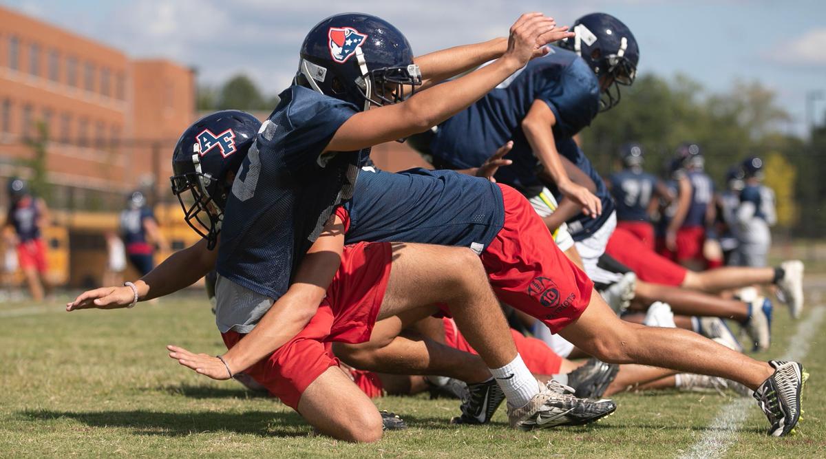 Apex Friendship High School football players work on their tackling technique without pads during practice on September 18, 2019 in Apex, N.C. Coach Adam Sanders has adopted no contact practices as a way to cut down on injures.