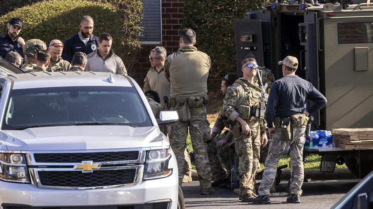 FBI agents and law enforcement officers work the scene of a standoff at Tryon Villages apartments Wednesday, Feb. 22, 2023.