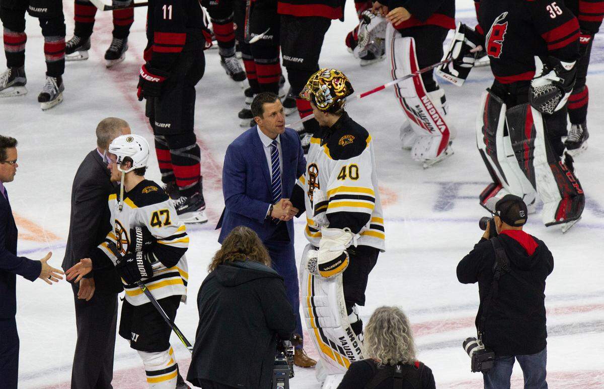 Carolina Hurricanes head coach Rod Brind’Amour congratulates Boston’s Tuukka Rask (40) at the conclusion of of Game 4 of the Eastern Conference Finals Thursday, May 16, 20019 at PNC Arena in Raleigh, NC. The Bruins won 4-0.