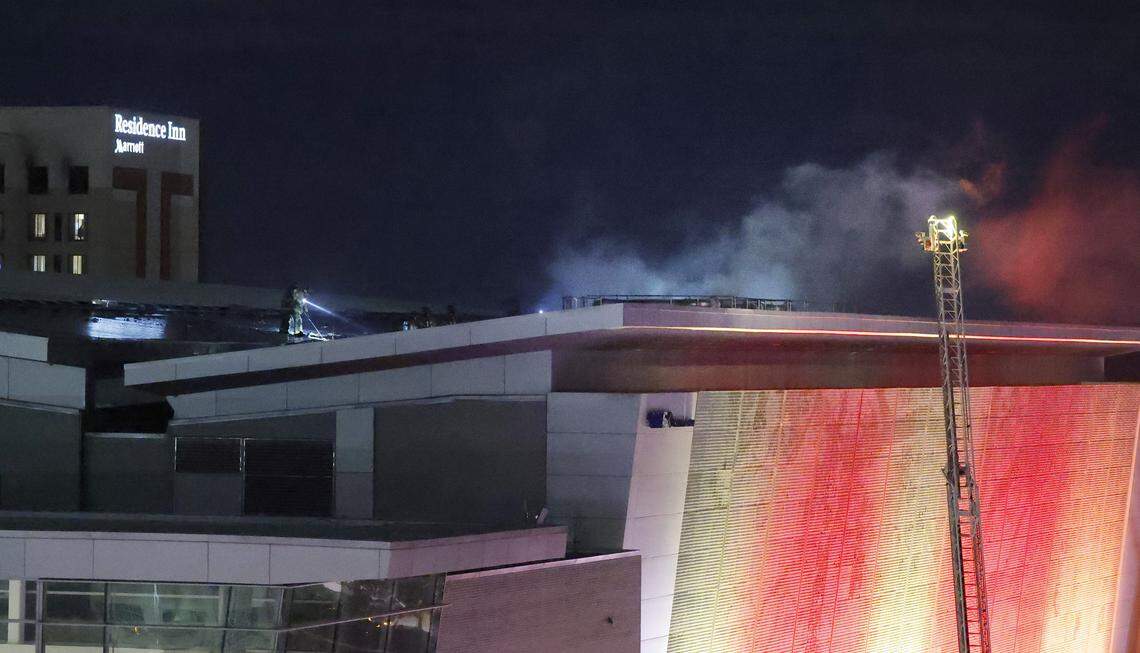 Firefighters work on the roof at the Raleigh Convention Center in downtown Raleigh, N.C., Monday evening, Dec. 1, 2025.