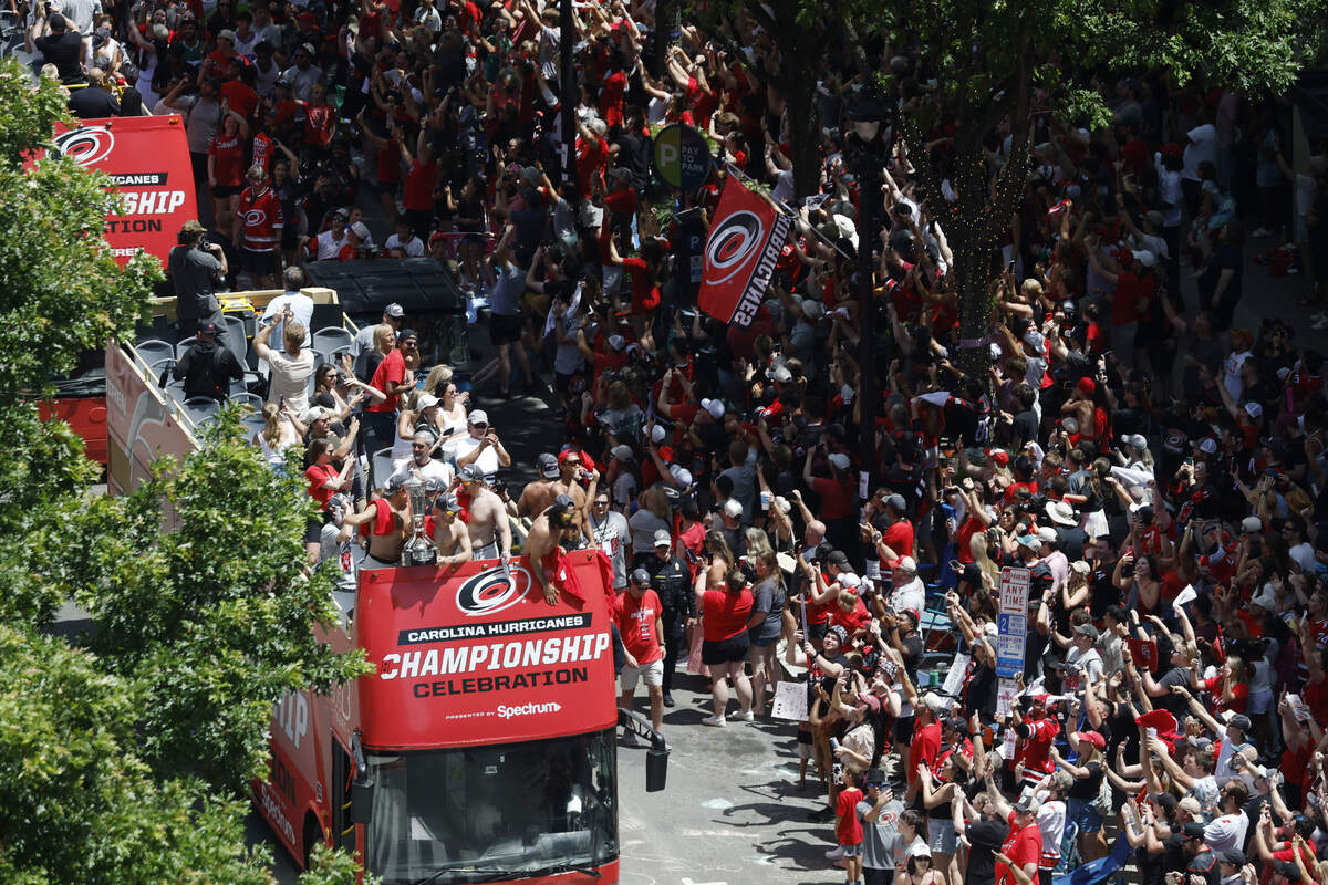 Buses carrying Carolina Hurricanes players and families along the parade route celebrating their Stanley Cup Championship.