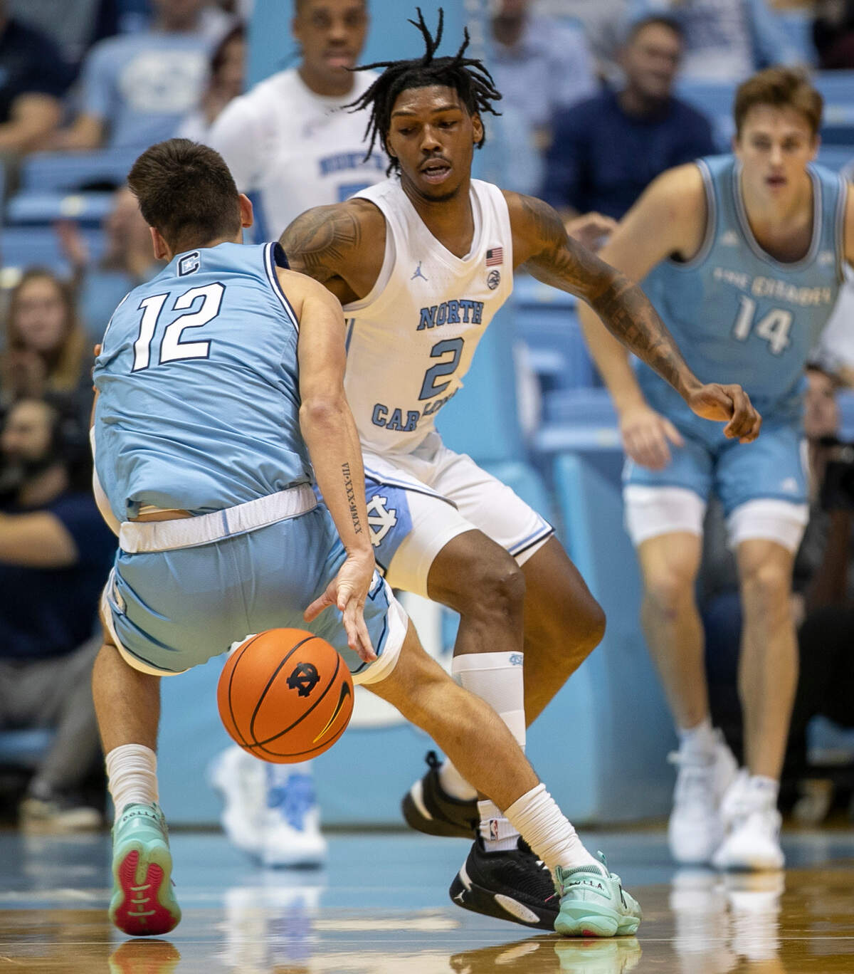North Carolina’s Caleb Love (2) defends The Citadel’s Colby McAllister (12) as he reverses his dribble in the second half on Tuesday, December 13, 2022 at the Smith Center in Chapel Hill, N.C.