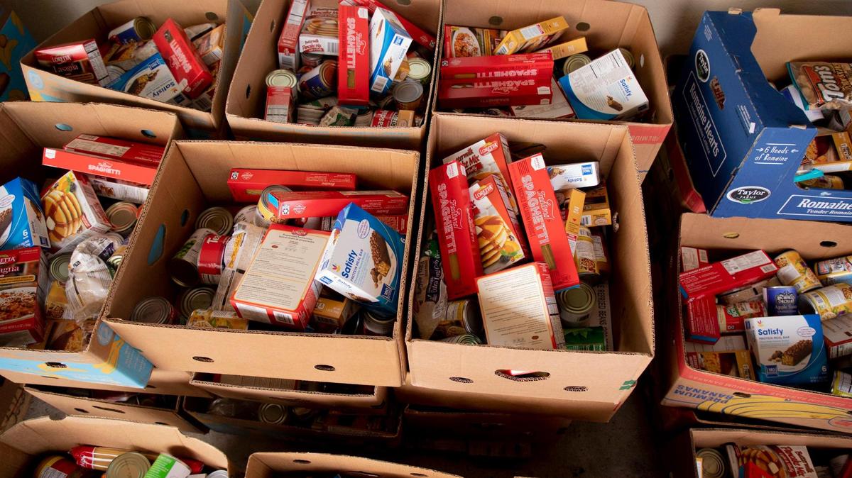 Boxes of food await distribution at the Durham Community Food Pantry, on Wednesday, Dec. 9, 2020, in Durham, N.C.