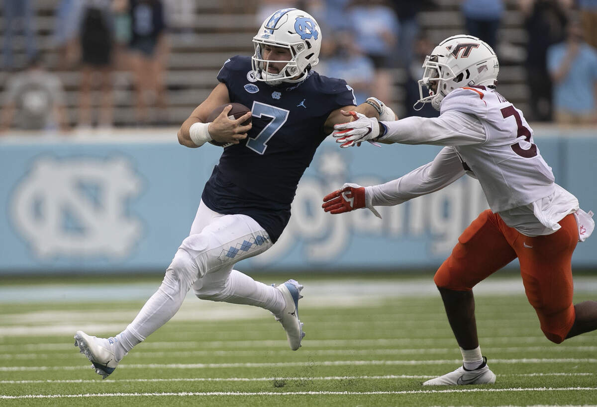 North Carolina quarterback Sam Howell (7) breaks away from Virginia Tech’s Alan Tisdale (34) for a 12-yard gain in the fourth quarter on Saturday, October 10, 2020 at Kenan Stadium in Chapel Hill, N.C.