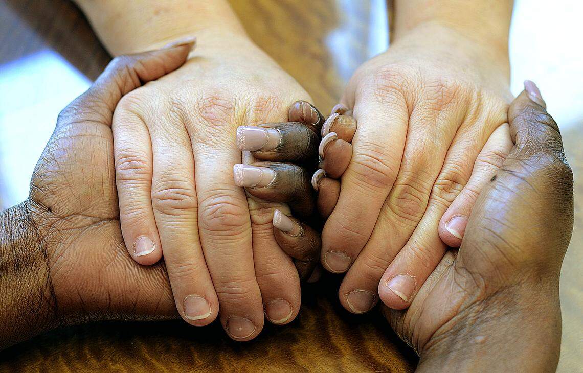 ROBERT C. REED/HICKORY DAILY RECORD: Donyetta Gilmer, sexual assault and domestic violence advocate, holds the hands of a sexual assault victim during a counseling session.