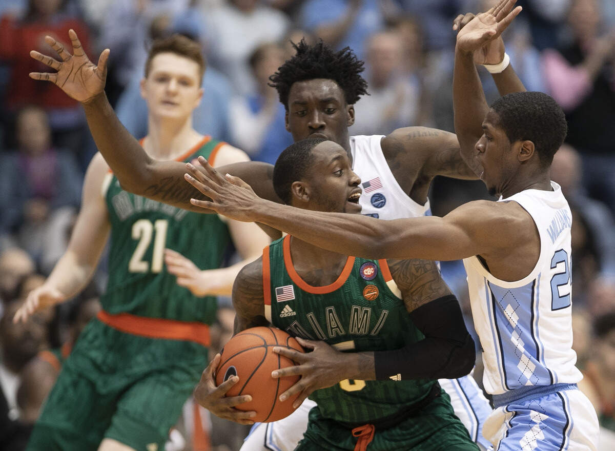 Miami’s Zach Johnson (5) is trapped by North Carolina’s Kenny Williams (24) and Nassir Little (5) during the second half on Saturday, February 9, 2019 at the Smith Center in Chapel Hill, N.C.
