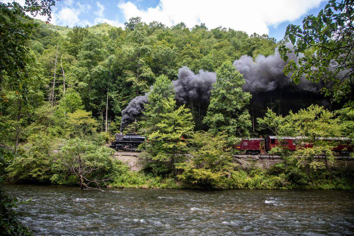 The Great Smoky Mountain Railroad steam engine chugs along the Nantahala river during a Nantahala Gorge excursion.