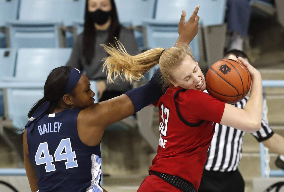 N.C. State’s Elissa Cunane (33) pulls in a rebound from North Carolina’s Janelle Bailey (44) during the first half of N.C. State’s game against UNC at Carmichael Arena in Chapel Hill, N.C., Sunday, February 7, 2021.