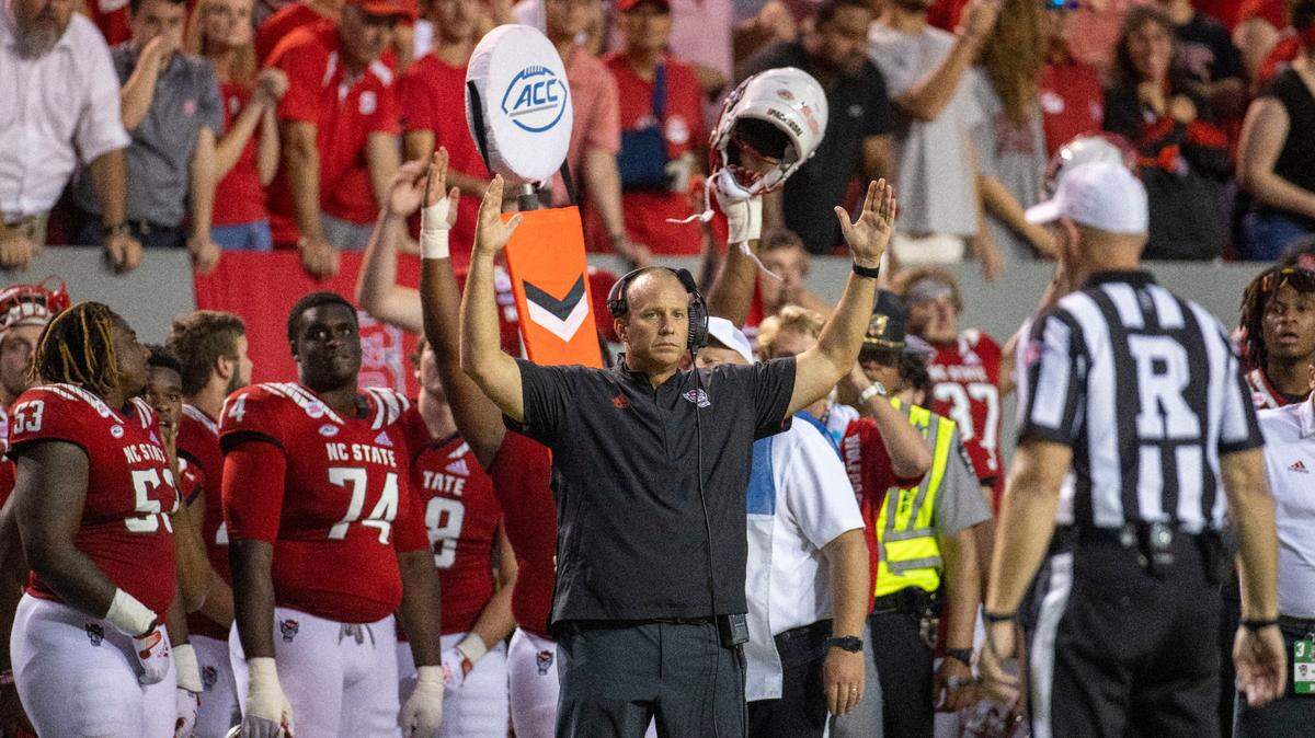 N.C. State coach Dave Doeren signals touchdown as he waits for the officials to review a 22-yard touchdown catch by Devin Carter in the second overtime against Clemson on Saturday September 25, 2021 at Carter-Finley Stadium in Raleigh, N.C.