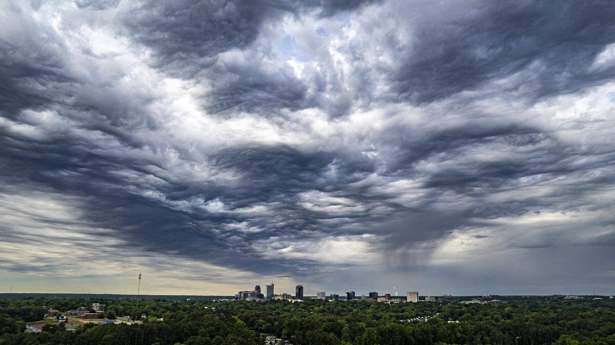 Dramatic clouds gather over Raleigh as light rain falls in parts of the city Tuesday morning, April 28, 2026. All 100 North Carolina counties are in moderate to extreme drought conditions, according to the North Carolina Drought Management Advisory Council.