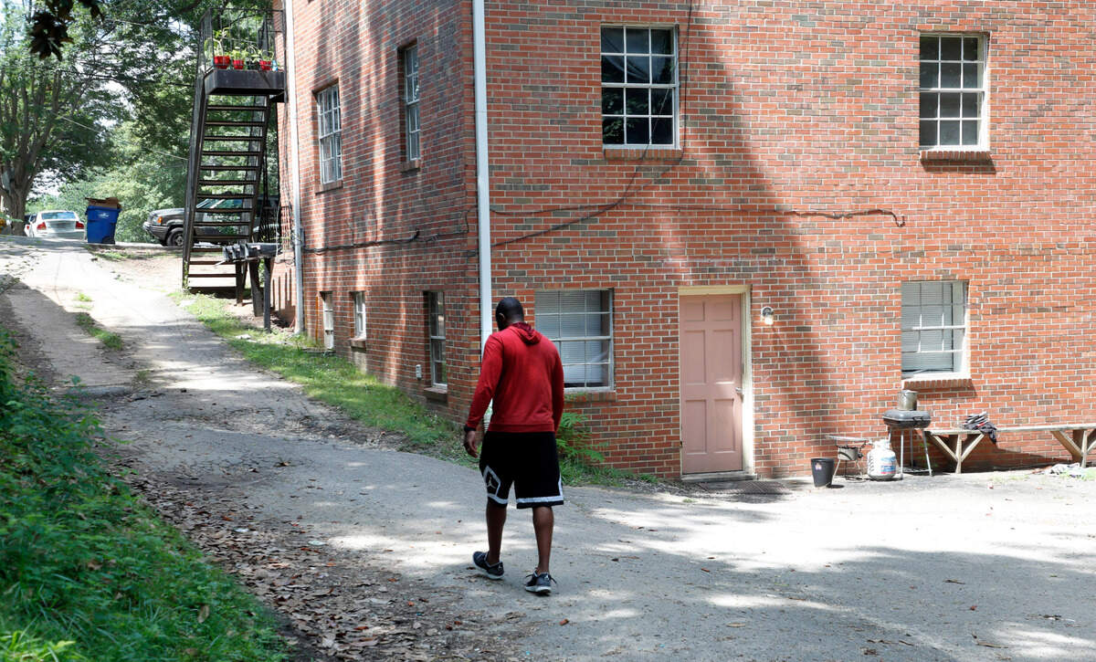 LeVelle Moton walks past the apartment he grew up in Raleigh, N.C., Wednesday, June 23, 2021.
