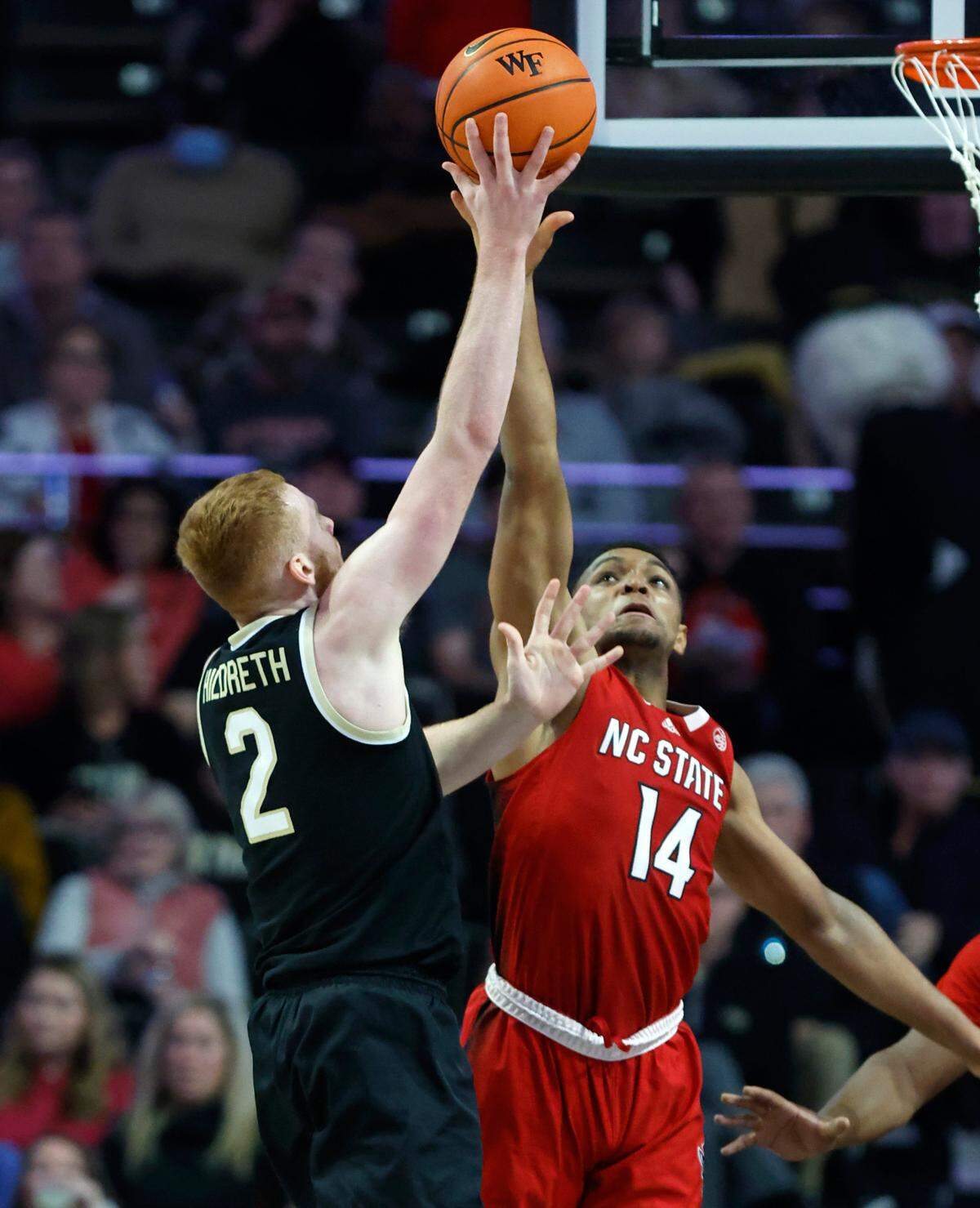 N.C. State’s Casey Morsell (14) blocks the shot by Wake Forest’s Cameron Hildreth (2) during the second half of N.C. State’s 79-77 victory over Wake Forest at Joel Coliseum in Winston-Salem, N.C., Saturday, Jan. 28, 2023.