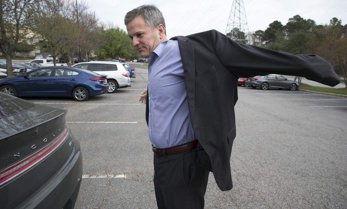 North Carolina Attorney General Josh Stein slips into his suit jacket in the parking lot of the Sheraton RTP, as he arrives for a lunch meeting and roundtable discussion on the opioid crisis in North Carolina hosted by Duke University on Wednesday, April 11, 2018 in Research Triangle Park, N.C.