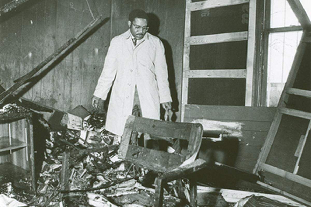 Lawyer Julius Chambers searches through his firebombed office in Charlotte, NC in February, 1971. His Charlotte home and car also were firebombed in 1965. Observer File Photo