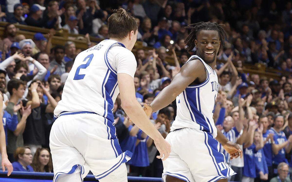 Duke’s Sion James (14) celebrates with Cooper Flagg (2) after Flagg threw up an alley-oop for Khaman Maluach during the second half of Duke’s 88-65 victory over Virginia Tech at Cameron Indoor Stadium in Durham, N.C., Tuesday, Dec. 31, 2024.