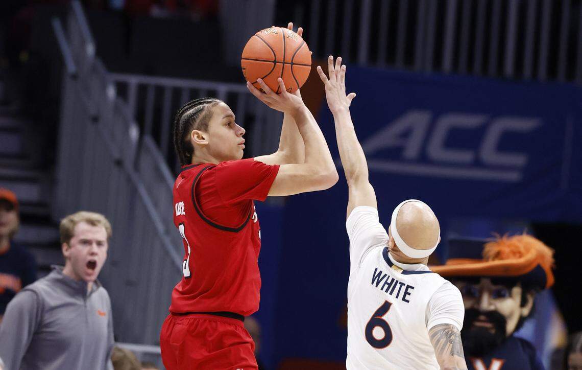N.C. State's Matt Able (3) shoots as Virginia's Jacari White (6) defends during the first half of N.C. State’s game against Virginia in the quarterfinals of the 2026 ACC Men’s Basketball Tournament at the Spectrum Center in Charlotte, N.C., Thursday, March 12, 2026.