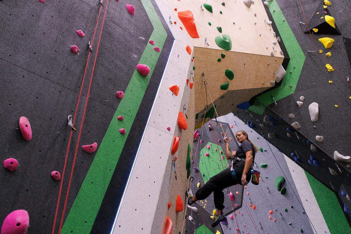 Bailey Rudd climbs at Triangle Rock Club’s new facility in Raleigh’s Salvage Yard on Friday, Sept. 27, 2024. The Salvage Yard site is the sixth location for the company and will be its biggest facility.