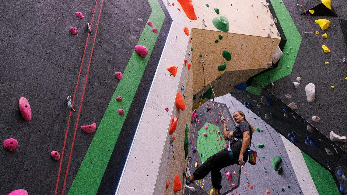 Bailey Rudd climbs at Triangle Rock Club’s new facility in Raleigh’s Salvage Yard on Friday, Sept. 27, 2024. The Salvage Yard site is the sixth location for the company and will be its biggest facility.