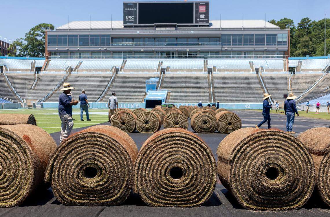 Crews from Carolina Green and the University of North Carolina Turf Management install nearly 100,000 square feet of fresh sod atop the artificial turf in Kenan Stadium in preparation for the FC Series game between Chelsea and Wrexham on Wednesday, July 12, 2023 in Chapel Hill, N.C. The Bermuda 419 sod was grown in Indian Trail, N.C., is 1.5 inches thick, and was installed upon a layer of geo-textile base over the artificial turf. It will be removed following the soccer match on July 19, 2023.