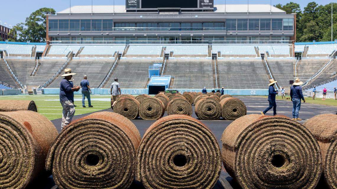 Crews from Carolina Green and the University of North Carolina Turf Management install nearly 100,000 square feet of fresh sod atop the artificial turf in Kenan Stadium in preparation for the FC Series game between Chelsea and Wrexham on Wednesday, July 12, 2023 in Chapel Hill, N.C. The Bermuda 419 sod was grown in Indian Trail, N.C., is 1.5 inches thick, and was installed upon a layer of geo-textile base over the artificial turf. It will be removed following the soccer match on July 19, 2023.