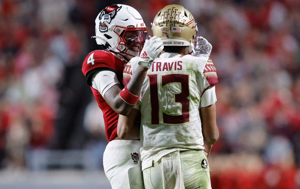 N.C. State safety Cyrus Fagan (4) talks with Florida State quarterback Jordan Travis (13) during the second half of N.C. State’s 19-17 victory over Florida State at Carter-Finley Stadium in Raleigh, N.C., Saturday, Oct. 8, 2022.