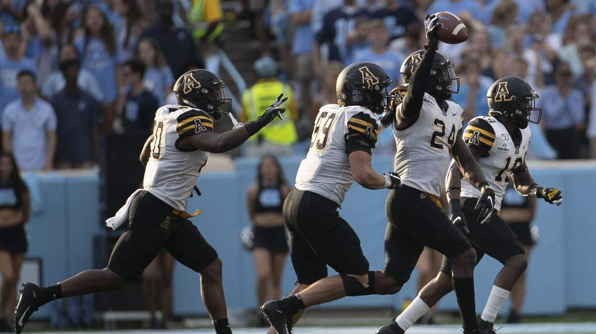 Appalachian State’s Akeem Davis-Gaither (24) celebrates after intercepting North Carolina quarterback Sam Howell last season in Chapel Hill. The Mountaineers were scheduled to play Wisconsin this season but that game was canceled due to the coronavirus pandemic.