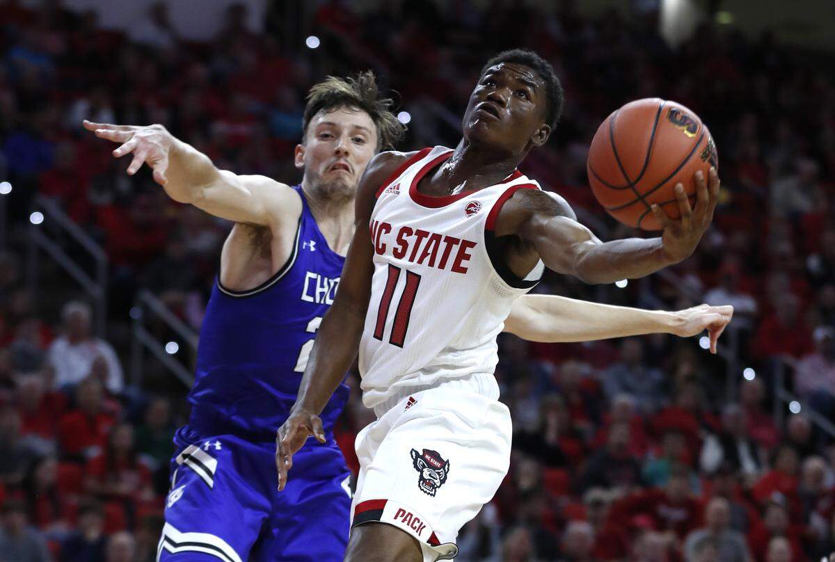 N.C. State’s Markell Johnson (11) shoots while Chowan’s Jordan Marshall (22) defends during the first half of N.C. State’s exhibition game against Chowan at PNC Arena in Raleigh, N.C., Monday, Oct. 29, 2018.