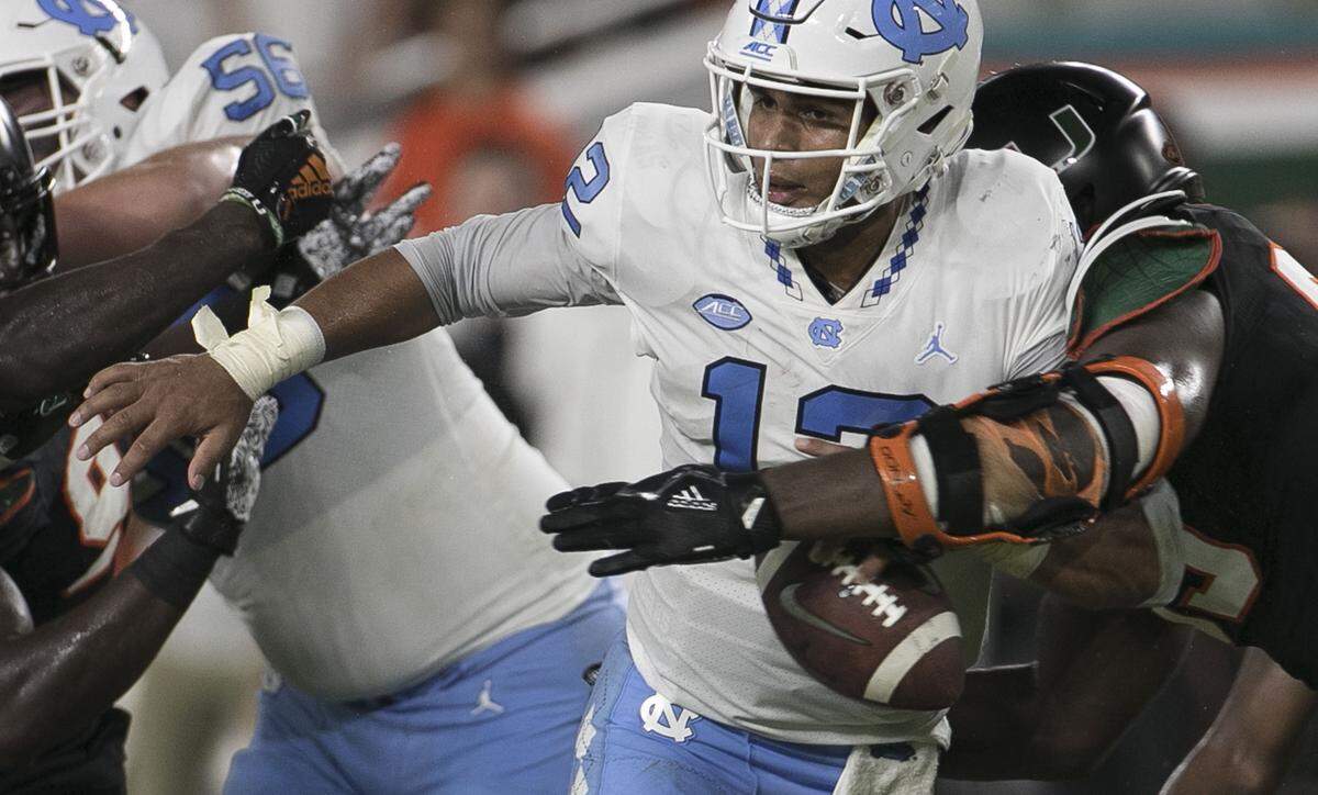 Miami’s Joe Jackson (99) forces a fumble and sacks North Carolina quarterback Chazz Surratt (12) in the second quarter on Thursday, September 27, 2018 at Hard Rock Stadium in Miami Gardens, Florida.